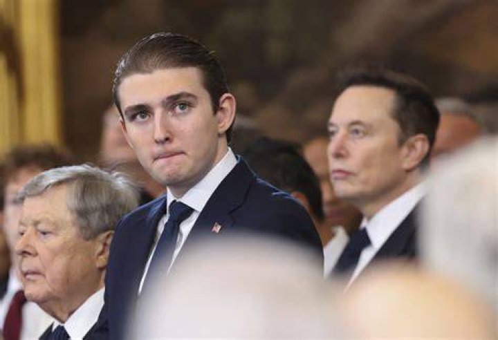 Barron Trump towers over Donald as family attend funeral of Melania's