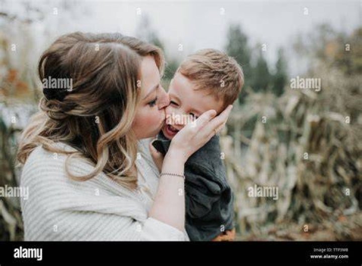 Mother Kissing Son Stock Image F003/7380 Science Photo Library