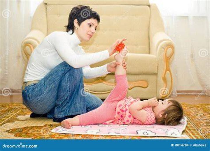 The Mother Makes the Massage of the Back of His Little Son. Stock Image